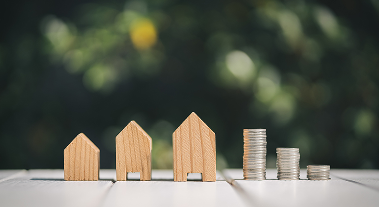 Small homes and stacks of coins.