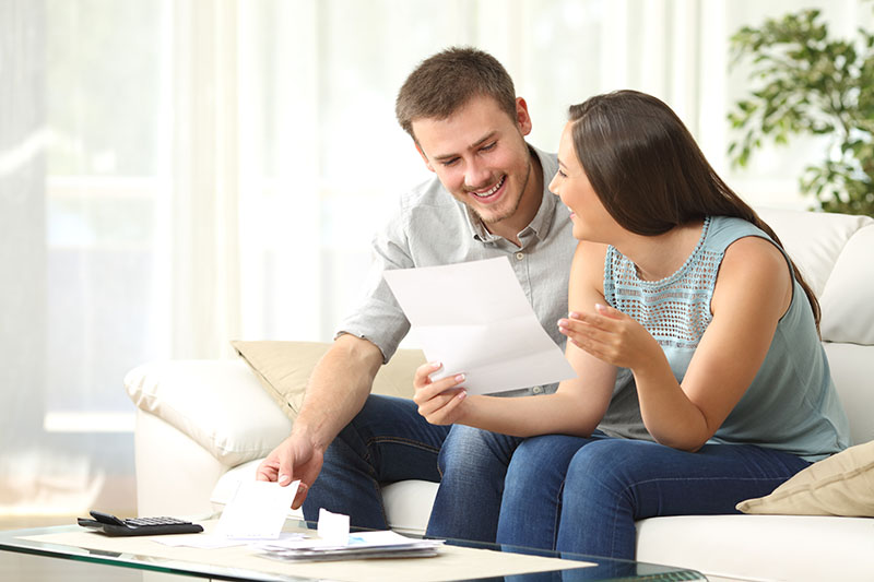 Couple going over information for their home down payment.
