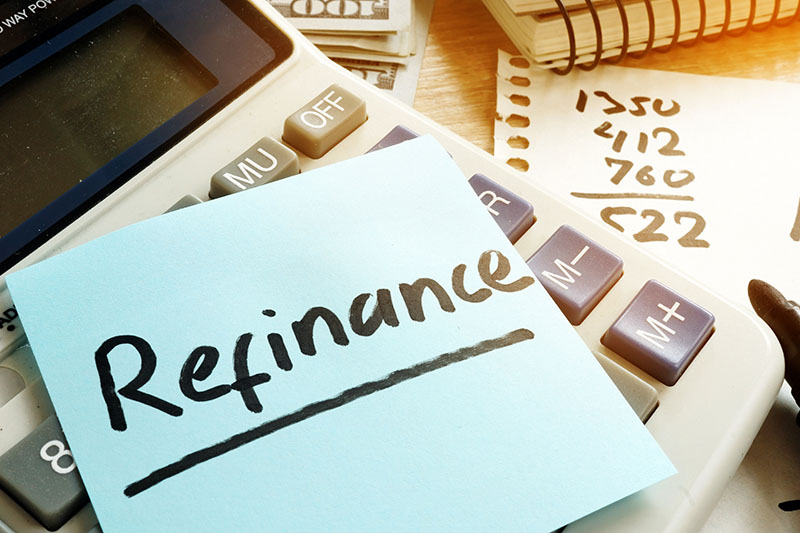 Refinance written on a memo to refinance a home.